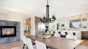 Provincial 6 light chandelier above a dining room table in an open concept home.