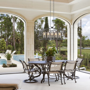 Botanic arches outdoor linear chandelier hanging above an outdoor living dining table..