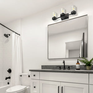 3 light Devonshire vanity in matte black hanging in a bathroom..