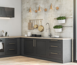 3 Moti swing arm wall sconces in brushed gold on the wall in the kitchen.